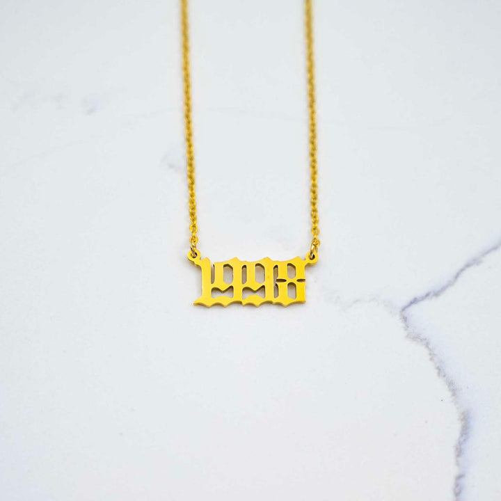 1998 Nameplate Necklace - Gold on White Marble